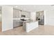 Bright kitchen features gray cabinets, granite countertops, and stainless steel appliances at 1737 Forest Run Ln, Auburndale, FL 33823