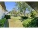 Green backyard and grassy area with trees and shrubs with high hedges and trees at 1741 Palmer Ave, Winter Park, FL 32789
