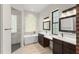 Luxurious bathroom featuring double sinks, a soaking tub, and a walk-in shower with tile surround at 1741 Palmer Ave, Winter Park, FL 32789