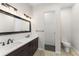 Modern bathroom featuring dual sinks, a large mirror, and a separate glass-enclosed shower at 1741 Palmer Ave, Winter Park, FL 32789