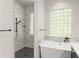 Modern bathroom showcasing a tub and shower, complemented by stylish tile work and dark hardware at 1741 Palmer Ave, Winter Park, FL 32789