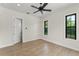 Bright bedroom features wood floors, ceiling fan and dual windows offering natural light at 1741 Palmer Ave, Winter Park, FL 32789