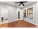 Bedroom featuring hardwood floors, a ceiling fan, and an ensuite bathroom at 1741 Palmer Ave, Winter Park, FL 32789