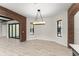 Bright dining room with brick archway, modern chandelier, and ample natural light from two windows at 1741 Palmer Ave, Winter Park, FL 32789