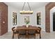 Dining room showcasing a modern chandelier, brick archway, and large windows, creating an elegant dining space at 1741 Palmer Ave, Winter Park, FL 32789