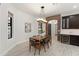 Dining area featuring a modern light fixture and access to additional rooms through the brick archways at 1741 Palmer Ave, Winter Park, FL 32789