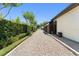 Charming driveway leading to home with tidy, trimmed green hedges on either side at 1741 Palmer Ave, Winter Park, FL 32789