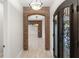 Stunning entryway with brick arch, wood-look tile flooring, and a beautiful wrought-iron front door at 1741 Palmer Ave, Winter Park, FL 32789