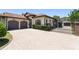 A stucco house has a tile roof, a two-car garage, a brick entry gate, and a paved driveway at 1741 Palmer Ave, Winter Park, FL 32789