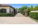 A stucco house has a tile roof, a brick entry gate, a private driveway, and mature landscaping at 1741 Palmer Ave, Winter Park, FL 32789