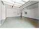 Clean and well-lit garage featuring epoxy flooring, a door to the house, and storage at 1741 Palmer Ave, Winter Park, FL 32789