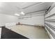 Spacious two-car garage with shelving, white walls and bright overhead lighting at 1741 Palmer Ave, Winter Park, FL 32789