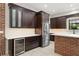 The kitchen boasts dark cabinets, stainless steel appliances, and a built-in wine fridge at 1741 Palmer Ave, Winter Park, FL 32789