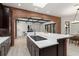 Kitchen featuring dark wood cabinets, a brick island with seating and open view to the dining and living areas at 1741 Palmer Ave, Winter Park, FL 32789