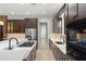 Gourmet kitchen features stainless steel appliances, dark cabinets, a central island, and modern finishes at 1741 Palmer Ave, Winter Park, FL 32789