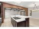 Spacious kitchen island with cooktop, blending seamlessly with the open living space featuring brick archways at 1741 Palmer Ave, Winter Park, FL 32789