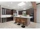 Modern kitchen with dark cabinetry, stainless steel appliances, brick-clad island with seating and light counter at 1741 Palmer Ave, Winter Park, FL 32789