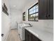 Bright laundry room with large windows and white washer and dryer units at 1741 Palmer Ave, Winter Park, FL 32789