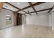 Bright open-concept living area with wood beams, a brick fireplace, and large windows for natural light at 1741 Palmer Ave, Winter Park, FL 32789