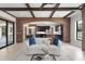 Spacious living room with brick archway, modern furnishings, light wood floors, and natural light at 1741 Palmer Ave, Winter Park, FL 32789