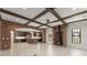 Spacious living room with wood beams, brick details, and fireplace, seamlessly connecting to the kitchen at 1741 Palmer Ave, Winter Park, FL 32789