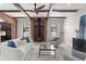 Spacious living room with wood beams, fireplace, comfortable seating, and bright windows at 1741 Palmer Ave, Winter Park, FL 32789