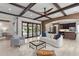 Open-concept living room with exposed wood beams, brick details, and seamless indoor-outdoor flow at 1741 Palmer Ave, Winter Park, FL 32789