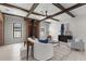 Bright living room featuring wooden beams, brick details, fireplace and modern furniture arrangement at 1741 Palmer Ave, Winter Park, FL 32789