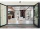 An open sliding glass doors gives view to the brick patio from the home's stylish living room and kitchen at 1741 Palmer Ave, Winter Park, FL 32789