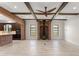 Spacious living room with a brick fireplace, wood beams, modern fan, and wood-look floors at 1741 Palmer Ave, Winter Park, FL 32789