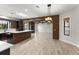 Open-concept living space with brick archway, a modern kitchen, and wood-look floors at 1741 Palmer Ave, Winter Park, FL 32789