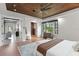 Bright main bedroom featuring wood ceiling, large window, and access to other rooms, creating an open and inviting space at 1741 Palmer Ave, Winter Park, FL 32789