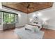 Spacious main bedroom with wood-paneled ceiling, a large window, and elegant furnishings, creating a serene retreat at 1741 Palmer Ave, Winter Park, FL 32789