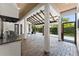 Covered outdoor patio featuring brick flooring, wood ceilings, and a stainless steel built-in grill at 1741 Palmer Ave, Winter Park, FL 32789