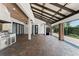 Covered patio includes a brick floor, stainless steel built-in grill, and retractable sliding glass doors at 1741 Palmer Ave, Winter Park, FL 32789