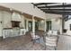 Entertainers patio with brick flooring, stainless steel appliances, solar roof, and comfortable seating at 1741 Palmer Ave, Winter Park, FL 32789