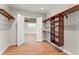 Large walk-in closet with wood flooring and custom wood shelving opens to a large bonus room at 1741 Palmer Ave, Winter Park, FL 32789