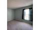 Bedroom showcasing carpeted flooring, a window with curtains, and a neutral wall color at 2009 Nottingdale Ln, Winter Park, FL 32792
