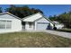 Charming single-Gathering home with a well-manicured front yard, brick driveway, and an attached two-car garage at 2009 Nottingdale Ln, Winter Park, FL 32792