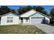 Charming single-Gathering home with a well-manicured front yard, brick driveway, and an attached two-car garage at 2009 Nottingdale Ln, Winter Park, FL 32792