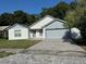 Charming single-Gathering home with a well-manicured front yard, brick driveway, and an attached two-car garage at 2009 Nottingdale Ln, Winter Park, FL 32792