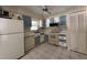 Functional kitchen featuring a double-bowl sink, dishwasher, stove and tile flooring at 2009 Nottingdale Ln, Winter Park, FL 32792