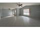 Spacious living room featuring tile flooring, a ceiling fan, and ample natural light from the large windows at 2009 Nottingdale Ln, Winter Park, FL 32792