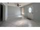 Bright living room with neutral paint, tile floors, ceiling fan, and natural light from the window at 2009 Nottingdale Ln, Winter Park, FL 32792