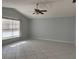 Spacious living room with neutral paint, tile floors, ceiling fan, and natural light from the window at 2009 Nottingdale Ln, Winter Park, FL 32792