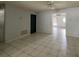 Open living room with tile flooring and ceiling fan, providing a bright and airy space at 2009 Nottingdale Ln, Winter Park, FL 32792
