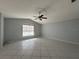 Expansive living room featuring tile flooring, ceiling fan, vaulted ceiling, and natural light at 2009 Nottingdale Ln, Winter Park, FL 32792