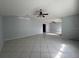 Expansive living room featuring tile flooring, ceiling fan, vaulted ceiling, and natural light at 2009 Nottingdale Ln, Winter Park, FL 32792