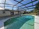 Captivating pool, set within a screened enclosure and surrounded by the home and a grassy yard at 2009 Nottingdale Ln, Winter Park, FL 32792