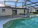 Sparkling pool with sun shelf, screened enclosure, and patio area accessible from the home at 2009 Nottingdale Ln, Winter Park, FL 32792